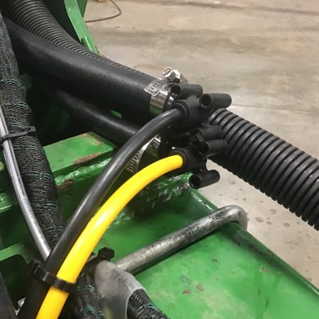 Although most systems are different this is generally how we will feed a vApply HD module. For this planter black equals 2x2 and yellow equals In-Furrow. This is done through a heavy EPDM hose that serves as a wet-boom.